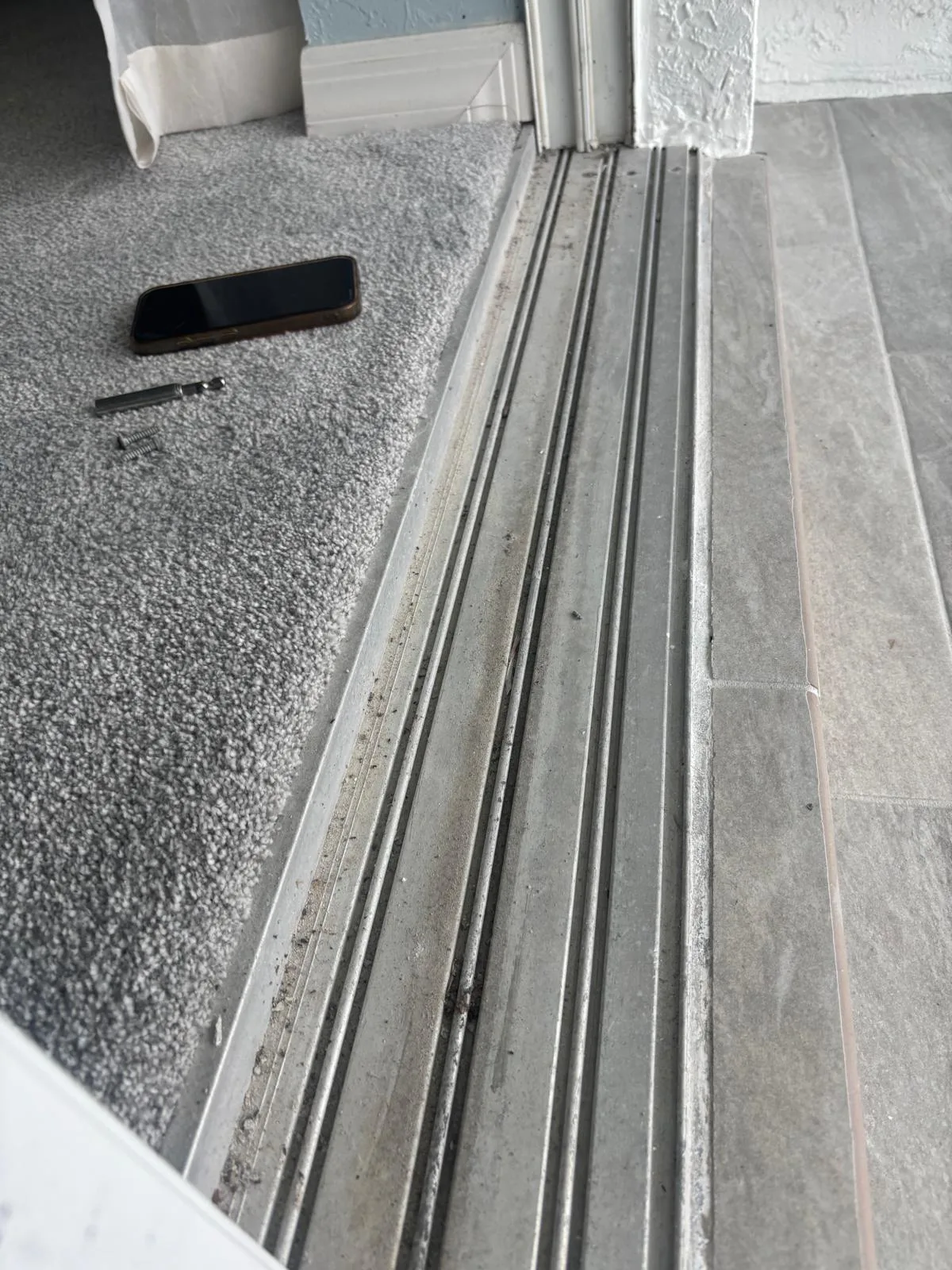 Technician repairing a sliding glass door track