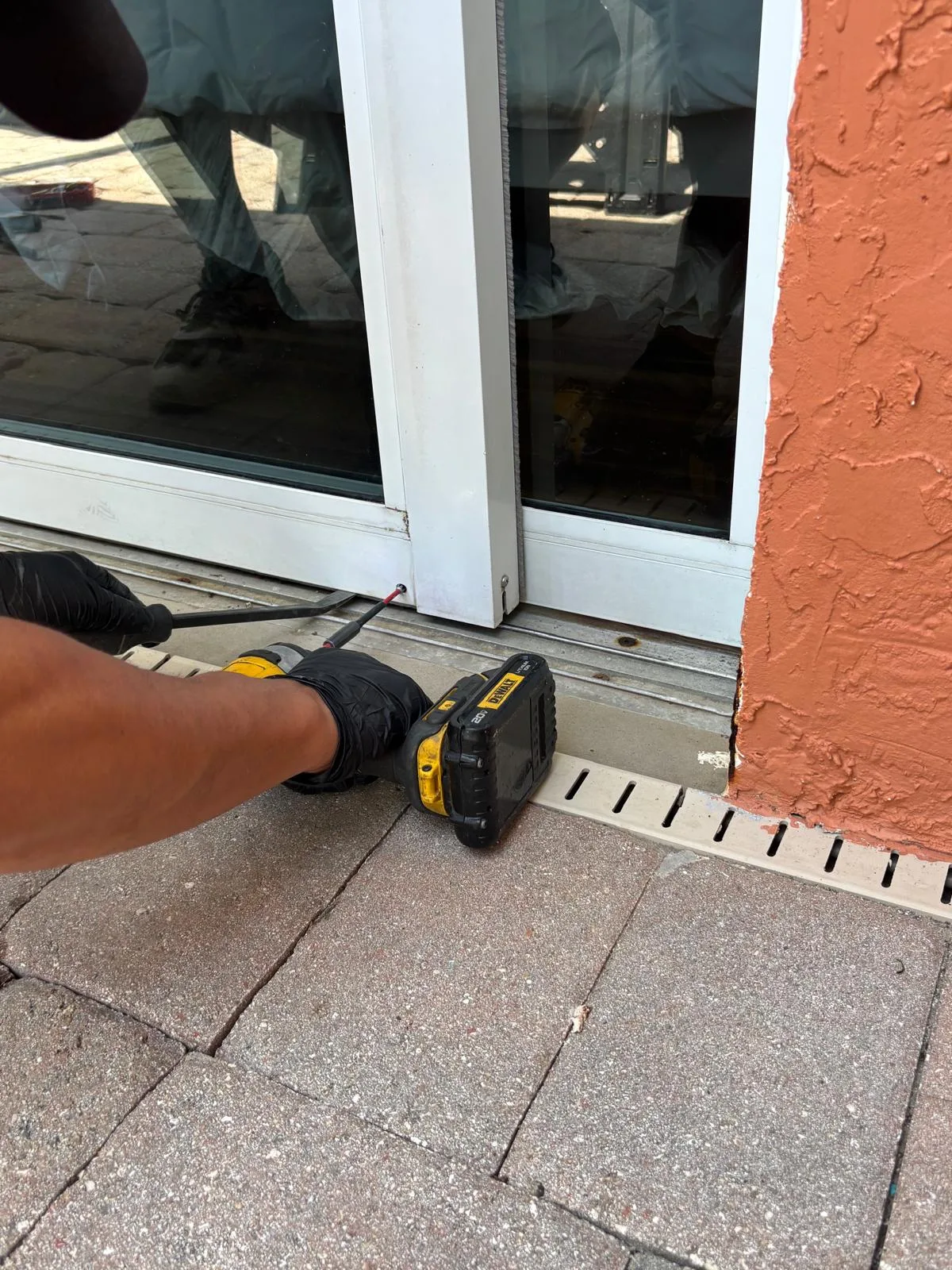 Technician adjusting sliding door rollers at a Hobe Sound home