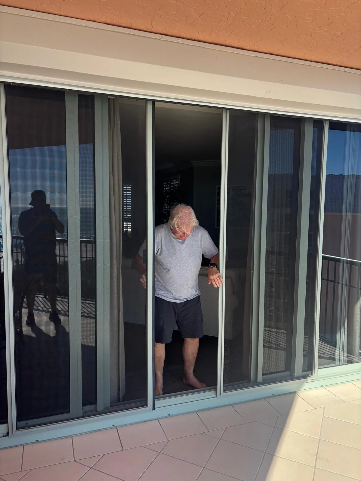 Customer testing screen door after repair