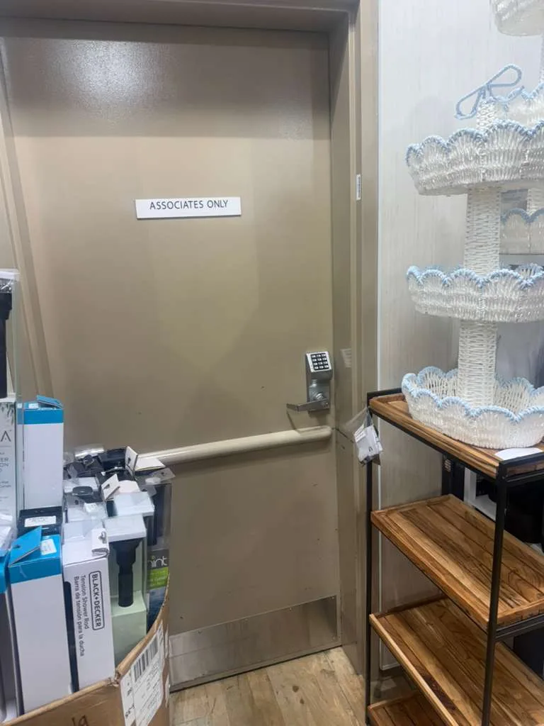 Technician repairing a commercial metal door on the Treasure Coast