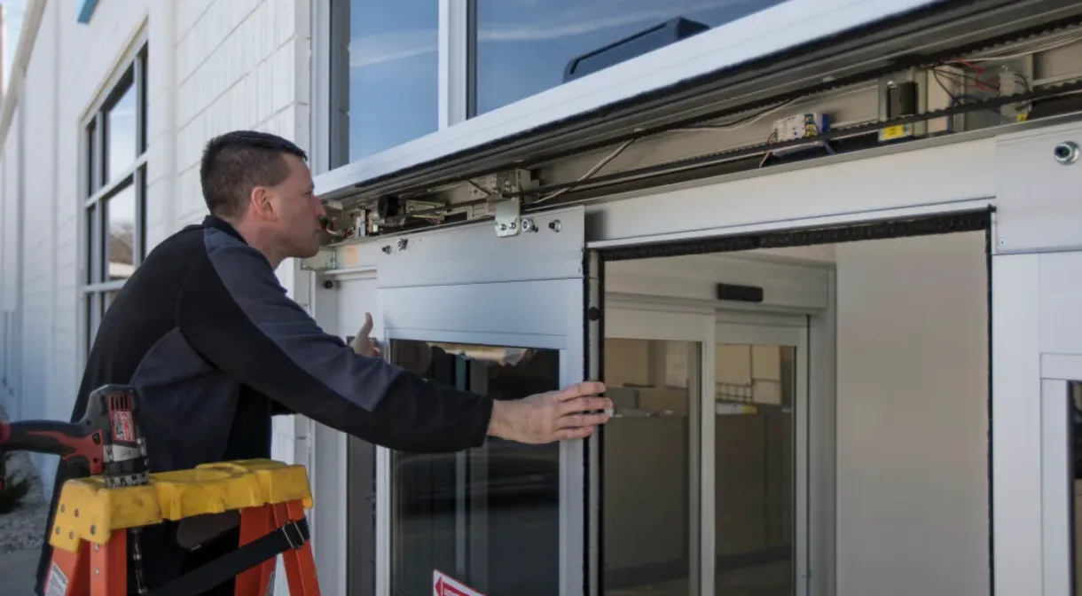 Technician working on an automatic storefront door
