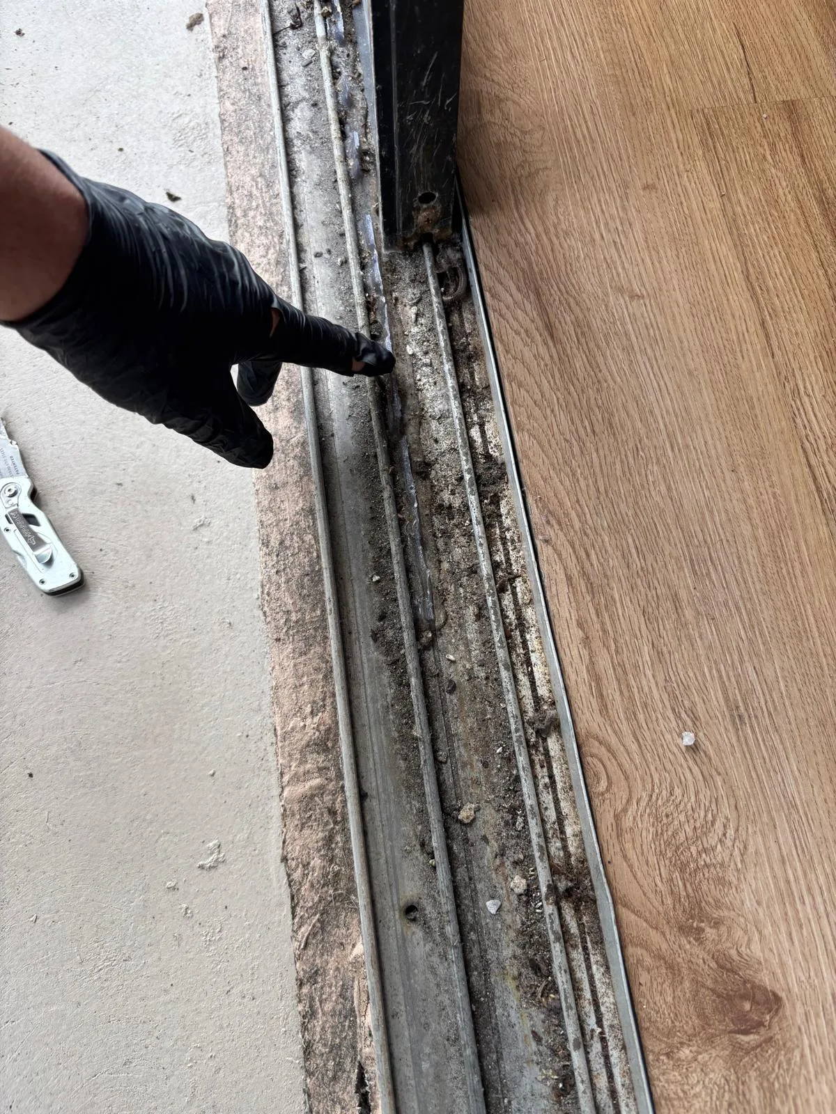 Damaged track showing rust and debris buildup