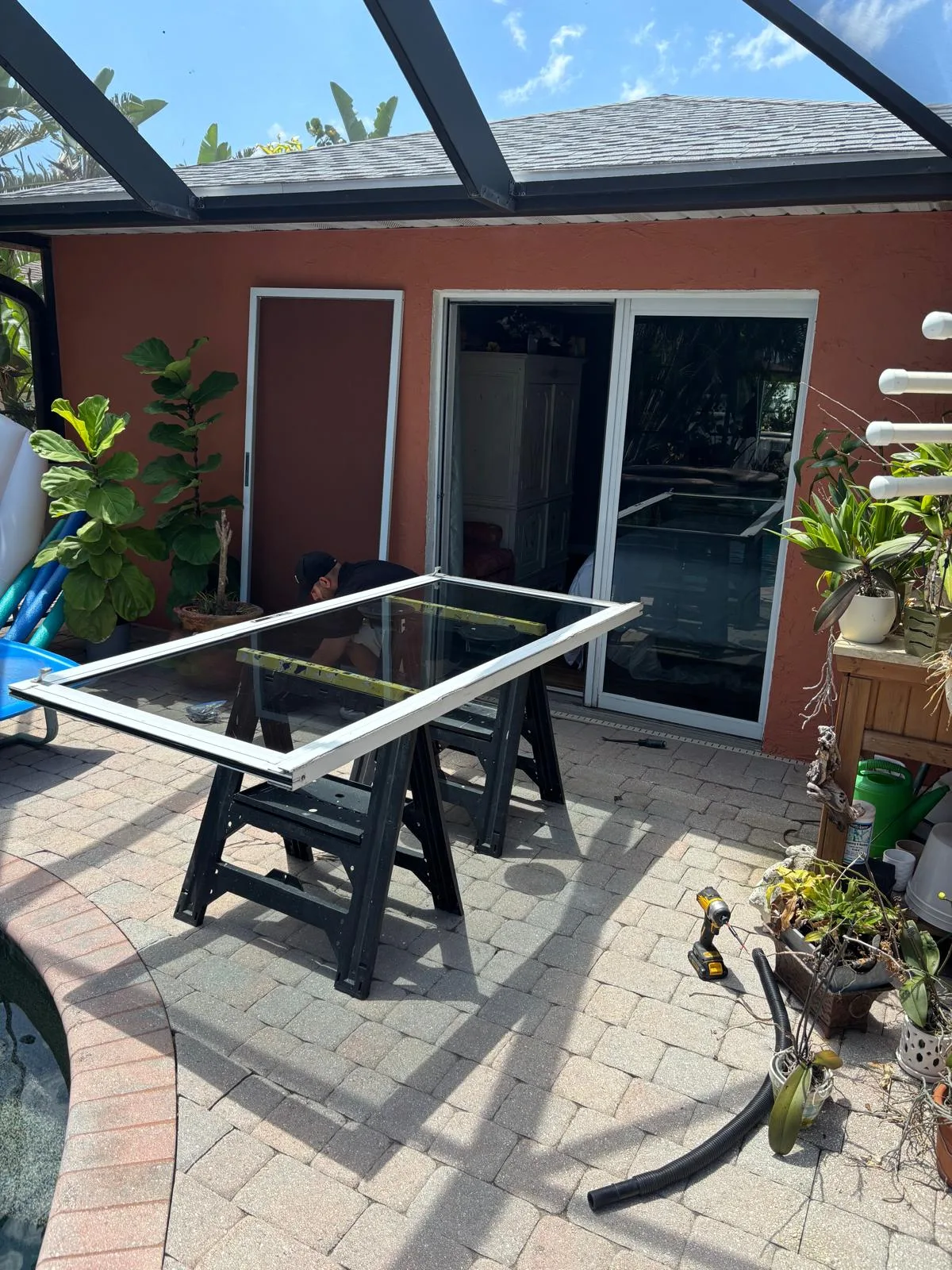 Technician working on a difficult-to-open sliding glass door panel